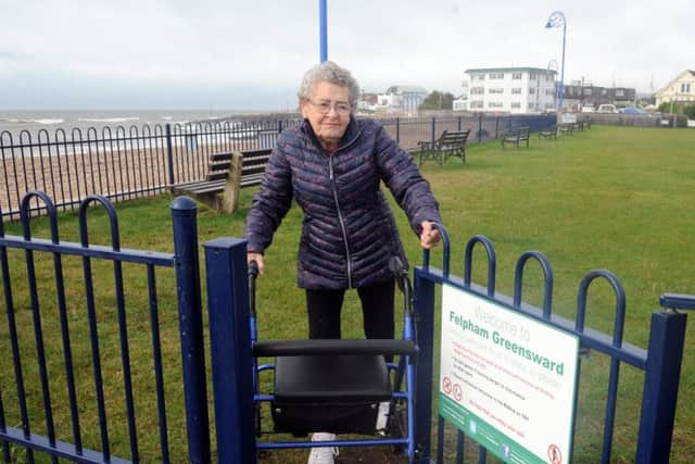 Councillor Mary Harvey demonstrating the difficulty that some would have negotiating the gate to the fenced off area