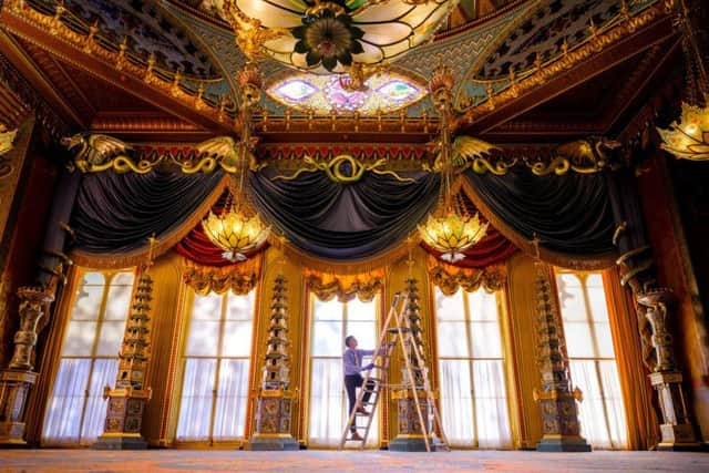 Senior decorative arts conservator of Royal Collection Trust David Wheeler installing the porcelain pagodas in the Royal Pavilion's music room. Photograph: Jim Holden