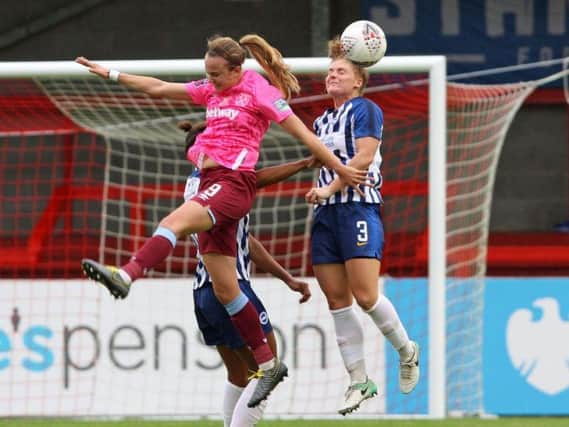 Fliss Gibbons heads clear for Brighton during their defeat against West Ham Ham at the People's Pension Stadium. By Geoff Penn