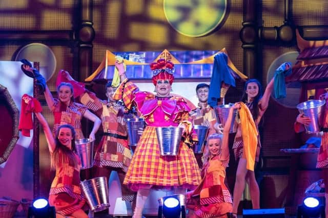 Widow Twankey (Tim McArthur) and the dancers. Photograph by Peter Mould