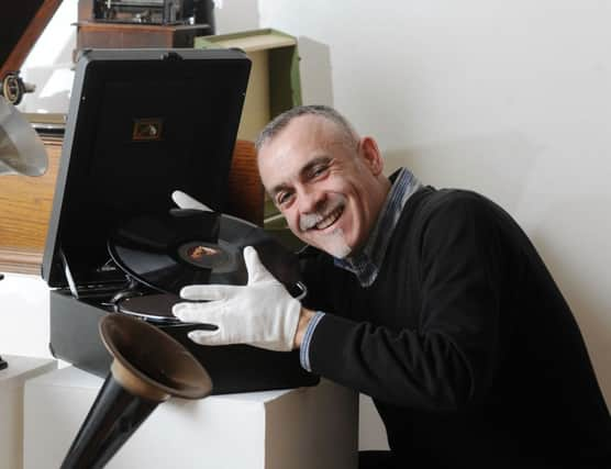 Museum curator Gerry Connolly setting up an exhibition