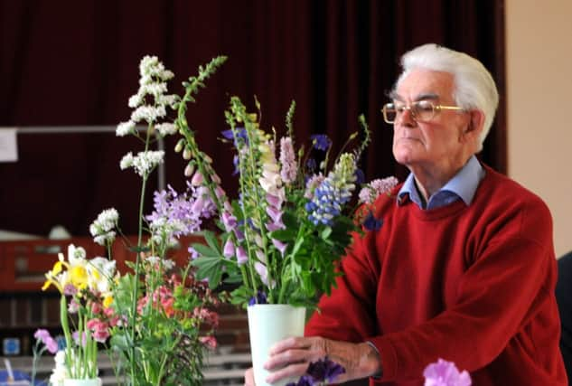 C130805-3 Bog Jun20 Walberton  phot kate

Judge Peter Collett with the Millenium cup winning exhibit of mixed cut flowers.Picture by Kate Shemilt.C130805-3