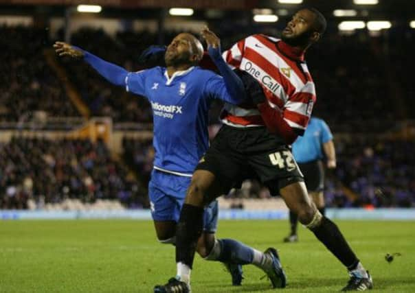 Birmingham City's Marlon King and Doncaster Rovers' Herold Goulon