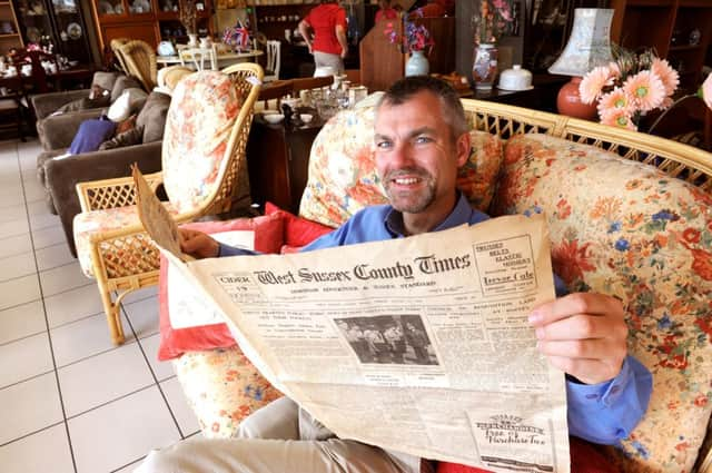 JPCT 280613 Old copy of the West Sussex County Times from 1942 found at Horsham Matters. David Sheldon, Chief Executive with the paper. Photo by Derek Martin