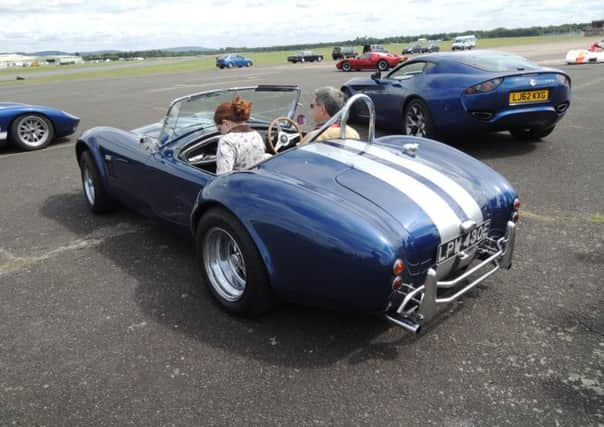 Another volunteer passenger tries out the AC Cobra.