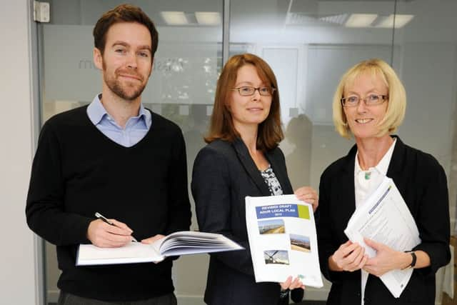 Senior planning policy officer Ben Daines, principal planning officer Moira Hayes and planning policy manager Colette Blackett look over the Adur Local Plan 2013 at Portland House in Worthing  W38132H13