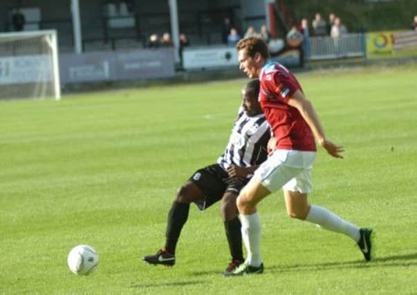 Hastings United full-back Jono Richardson challenges for the ball during the league win over Tooting & Mitcham United on Saturday. Picture by Simon Newstead