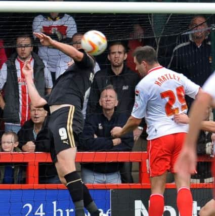 Stevenages's Peter Hartley scores the first goal against Crawley (Pic by Jon Rigby)