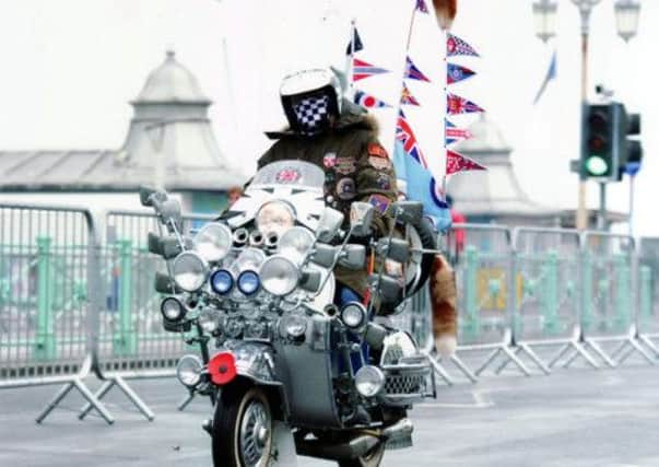 Roy Amos takes his Vespa scooter for a spin