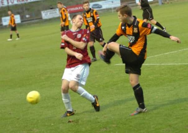 Charlie Slocombe takes evasive action during Hastings United's last home game against Three Bridges on December 7. Picture by Simon Newstead