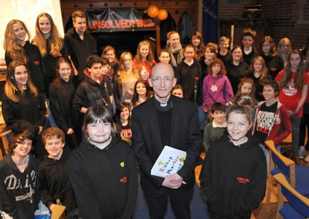 JPCT 100314 Petition handed to the Bishop of Chicheste Rt Revd Martin Warner to reconsider his decision to discontinue the small team of dedicated workers which focuses on supporting children and young people throughout Sussex. The Bishop receives the petition from Kirsty Sheath 11 left and Anna Carey 10. Photo by Derek Martin SUS-141103-120633001