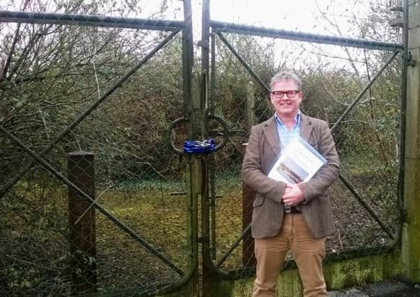 James Stewart, chairman of the Arundel Neighbourhood Plan steering group, at the gates of the old Arundel gasworks site SUS-140325-141140001