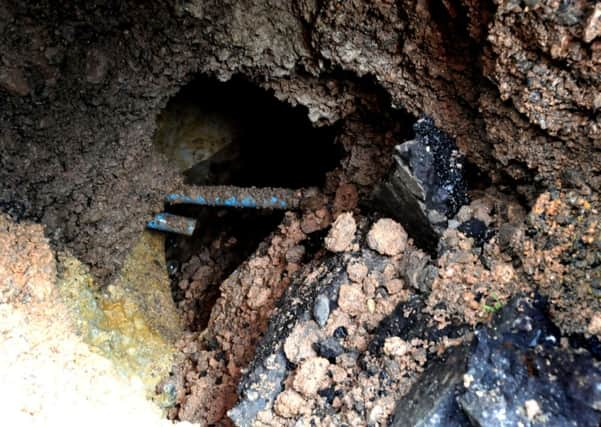 An area of pavement in South Road, Haywards Heath has dropped away causing a sink hole. view underneath the pavement. Pic Steve Robards SUS-140327-165230001