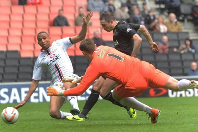 Michael Jones scores Crawley Town's second goal against MK Dons (Pic by Jon Rigby) SUS-141204-232106002