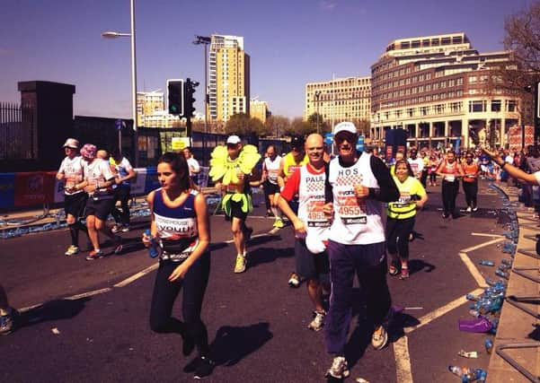 PAUL DAVIES AND 65 YEAR OF HARRIER HOS DAVIES RUNNING HIS FIRST MARATHON AT MILE 15 IN CANARY WHARF