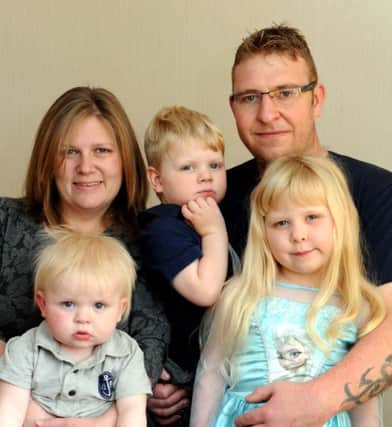 WH 190414  Joanne and Neil and their children L to R Zachery 1, Archie 2 and Imogen 5. Zachery and Imogen have Cystic Fibrosis and they are raising money. Photo by Derek Martin SUS-140420-234122001