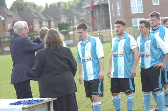 Bexhill United come up to collect their Sussex County Football League Division Two Challenge Cup runners-up medals. Picture by Simon Newstead