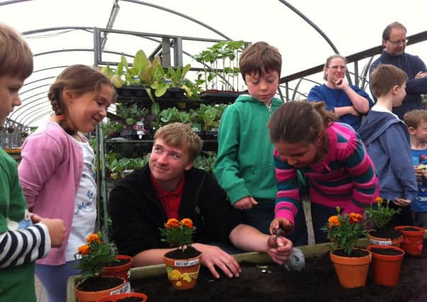 Young gardeners at Hillier Horsham SUS-140606-112419001