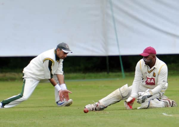 JPCT 070614 S14241069x Cricket. Broadbridge Heath v Crawley Eagles. BBH batting, blue he lmet Craig Skilton, green helmet, Neil Charman. Bowling towards camera Azam, Tliqat back to camera.  -photo by Steve Cobb SUS-140906-104626001