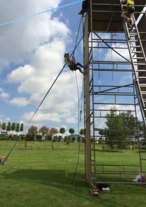 Rhiannon Weston-Smith, of the 2nd Angmering Brownies abseils down the wall SUS-140625-112533001