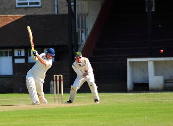 Bexhill captain Malcolm Johnson goes on the drive against Three Bridges. Picture by Steve Hunnisett (SUS-140621-180514002)