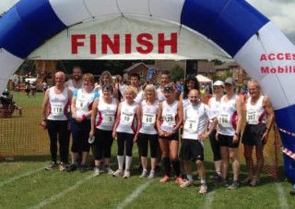 The Horsham Joggers Team at Sundays Downlands Dash 5 miler in Hassocks. Below: Helen Varcoe and Raff Vitale celebrate success in the Splash & Dash Triathlon at Christs Hospital School on Sunday