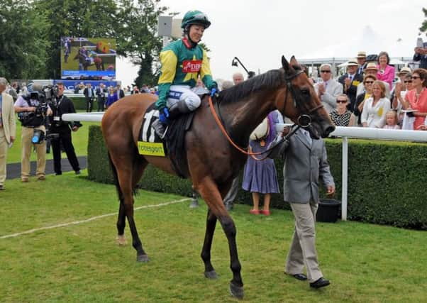 Boom and Bust and Hayley Turner in the winner's enclosure after their victory in the 2012 renewal of the Mile   Picture by Malcolm Wells