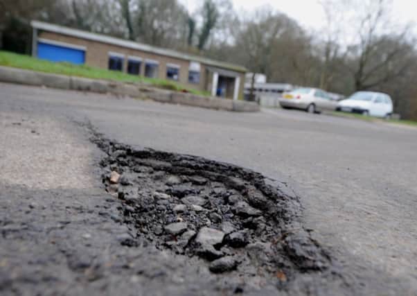 Pot holes in Lark Rise, Langley Green, Crawley (Pic by Jon Rigby) ENGSUS00120131101104139