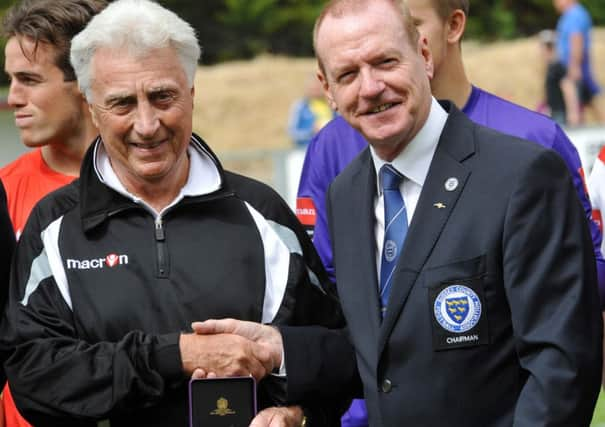 Mick Fogden is presented with his award for services to Sussex football by Sussex FA chairman Mathew Major