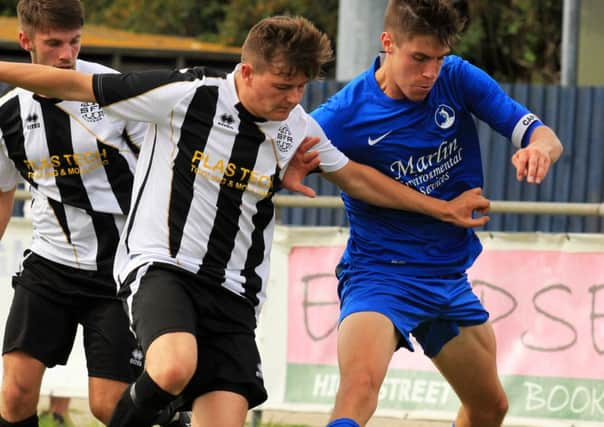 Selsey's captain David Rough (right) in action against St. Francis Rangers at the High Street Ground, Rangers won 2-1 in the first league game of the season. SUS-141008-174537002