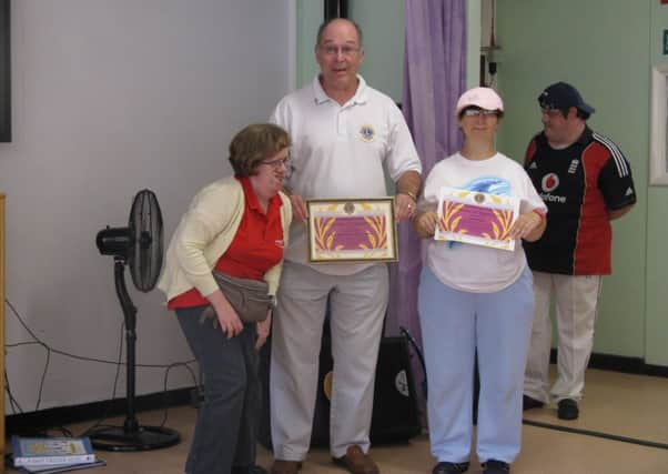 Stella Church (left) and Lorraine Battle (right) with Lion Tom Osborne SUS-141108-152708001