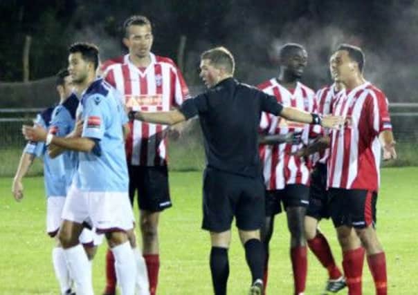 Things get a touch heated during Hastings United's 3-1 defeat away to Redhill on Tuesday night. Picture courtesy Joe Knight
