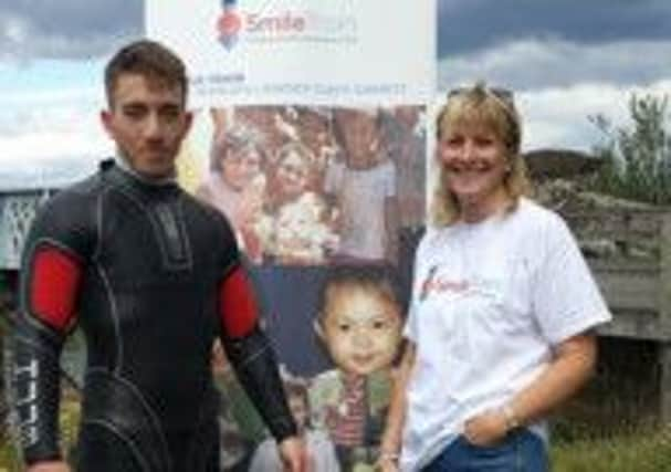 Nathan Abbott, 17, standing beside his proud mum Stephanie before setting off on his epic 15-mile swim for charity SUS-140826-125421001