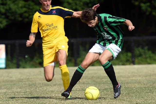 Football. Sussex League. Burgess Hill V Eastbourne Brough friendly. Action from the match.  Burgess Hill's Lee Harding takes the ball from  Eastbourne's Jay Lovett .   Picture: Liz Pearce 260714. SUS-140726-200949008