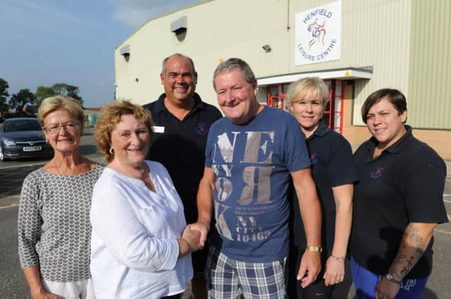 JPCT 090514 S14381703x Henfield Leisure Centre. HDC are giving a loan of £300k to Henfield Leisure Centre for a children's play area. Councillor Sheila Matthews shakes hands with Barrie Mitchell, president of Henfield and District Sports Association. With fellow member, wife Shirely Mitchell  and staff/management at the leisure centre -photo by Steve Cobb SUS-141009-085447001