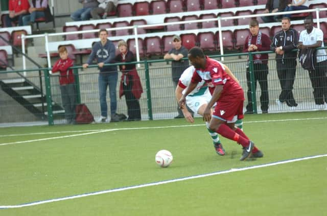 Hastings United striker Ade Olorunda tries to take on a Whyteleafe defender in the FA Cup on Saturday. Picture by Simon Newstead (SUS-140915-084307002)