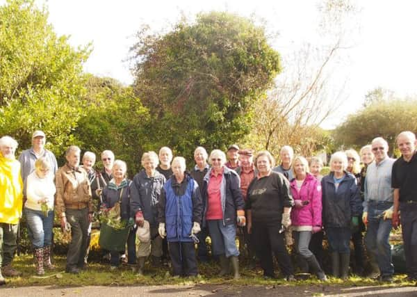 Twenty-five Ferring residents began restoring the Warren Pond last Saturday