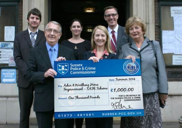 Jim Funnell from Adur and Mary Lermitte from Worthing receive the cheque from Mrs Katy Bourne (centre)