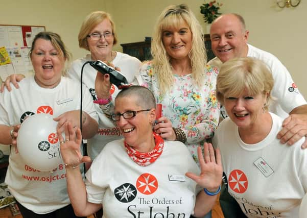 Debbie Lamb getting her head shaved by the team at St Wilfrids Arundel Priory             Photo: Derek Martin L45811H14