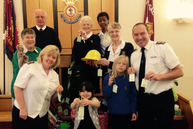 Horsham Salvation Army Toy Appeal 2014 - Major Ann Stewart is (far left front) and Major Iain Stewart (far right front) with volunteers with some of the prenents already donated - picture submitted