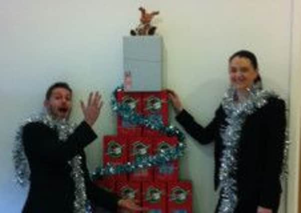 Michael Wheeler and Helen Britton from Regus in Horsham with some of the shoeboxes collected by the workplace provider for the 2014 Operation Christmas Child Appeal SUS-140912-164545001