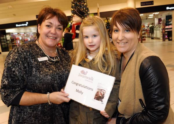 JPCT 161214 S14510275x Molly, 5, won a competition for the best selfie taken with the Swan Walk snowman. Gill Buchanan and mother Emma join Molly for photo - photo by Steve Cobb SUS-141216-163708001