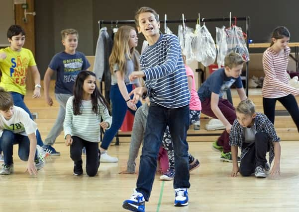 Cameron Cragg (foreground) with members of the 101 Dalmatians company. Photo Mike Eddowes