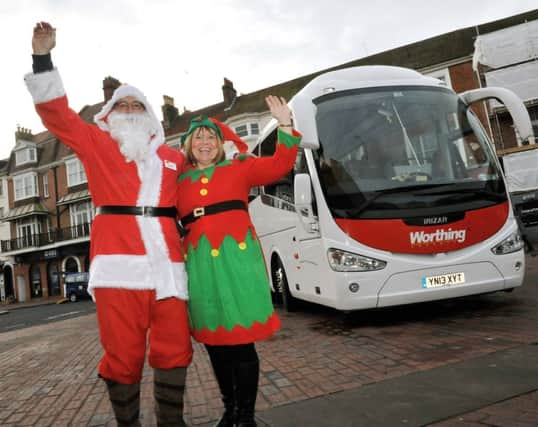 W50823H14

Father Chirstmas and his helper with Worthing Coaches new Coach in Montague Street on Monday SUS-141215-163506001