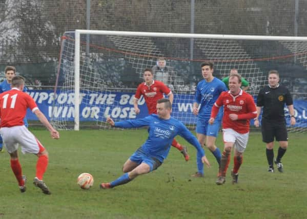 Mark Thompson is strong in the tackle for Selsey   Picture by Kate Shemilt  C141493-3