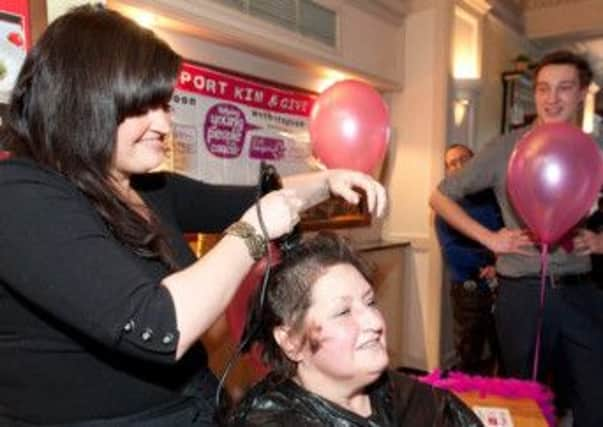 Kim Baccarini, of Littlehampton, as she lops off her locks for charity