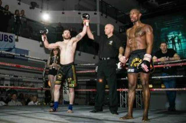 Pro tournament winner Ed Kelly raises his arms in victory at the latest Pantheon Fight Series show. Picture courtesy Flashback Photography Sussex