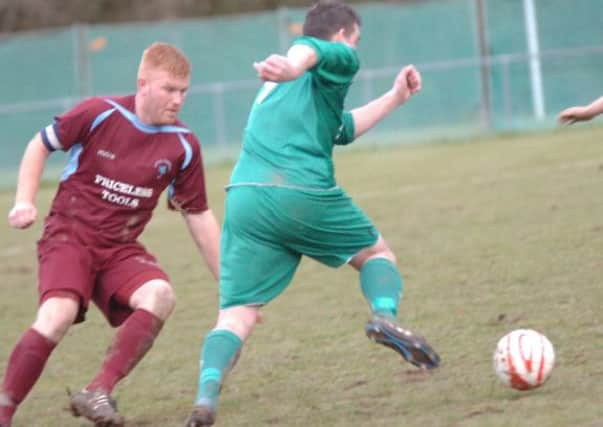 Little Common defender Zack McEniry tries to stop the advances of a Mile Oak opponent. Picture by Simon Newstead (SUS-150214-222844002)