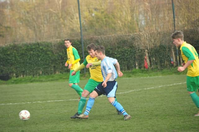 Westfield manager Jethro Warren keeps a close eye on a Worthing United opponent. Picture by Simon Newstead (SUS-150315-212559002)