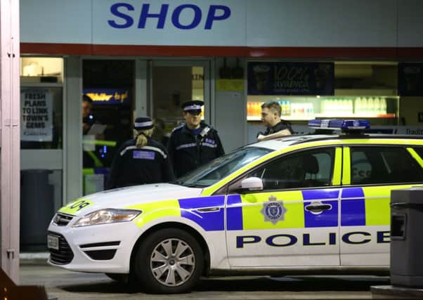 Police outside the garage in Littlehampton     PHOTO: Eddie Mitchell SUS-150317-151009001